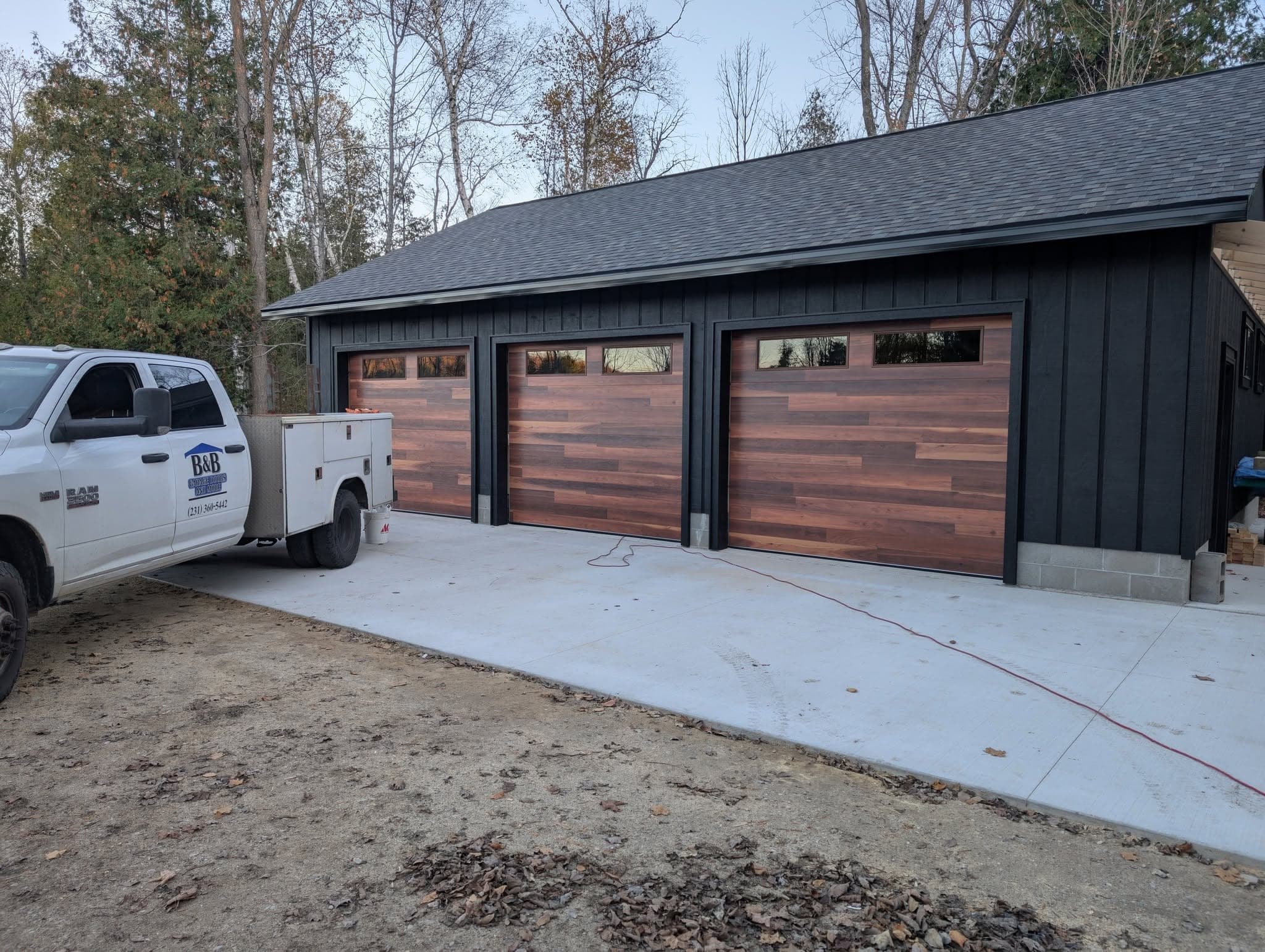 Three woodgrain doors on a steel building